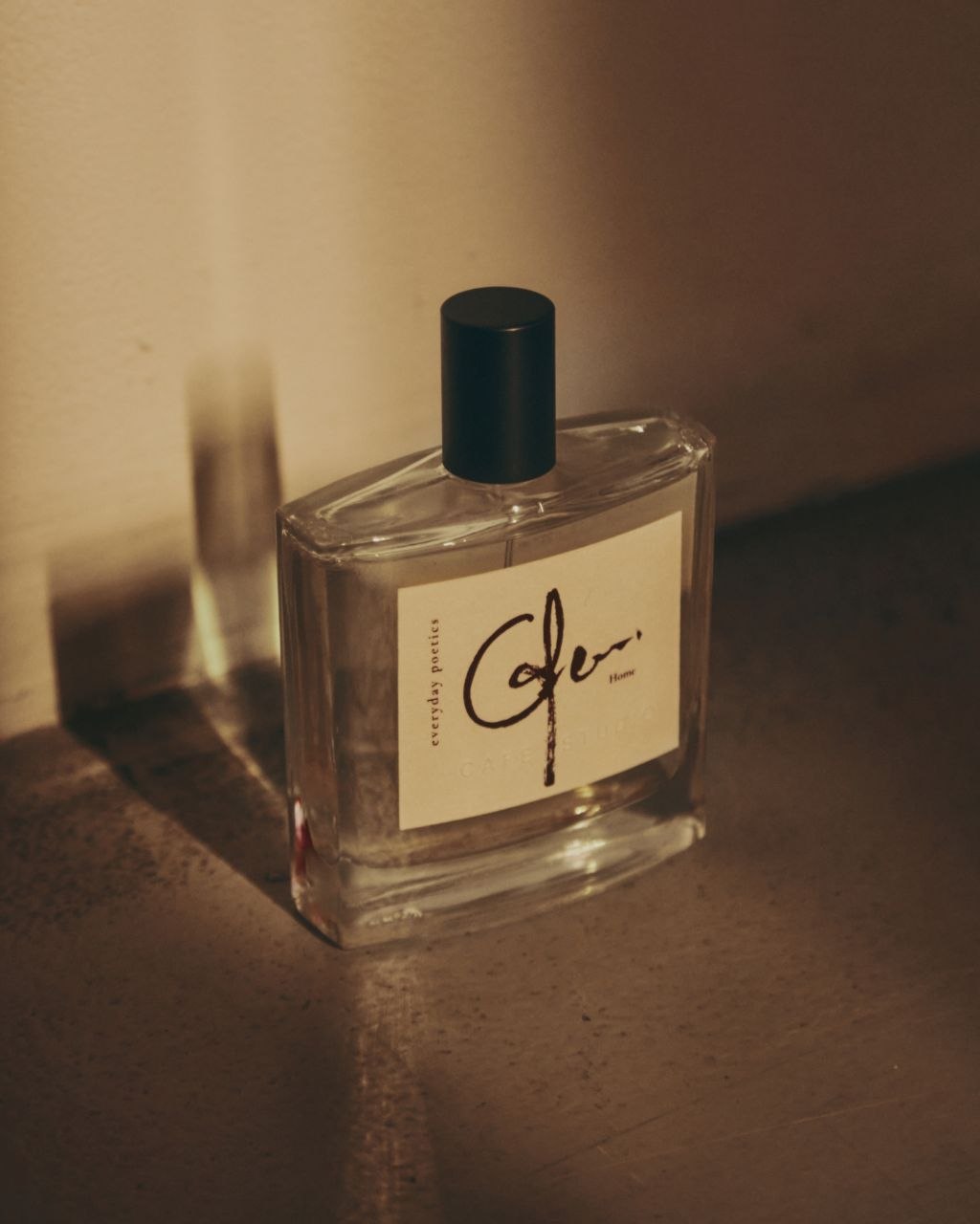 Everyday Poetics fragrance bottle on a dark surface.